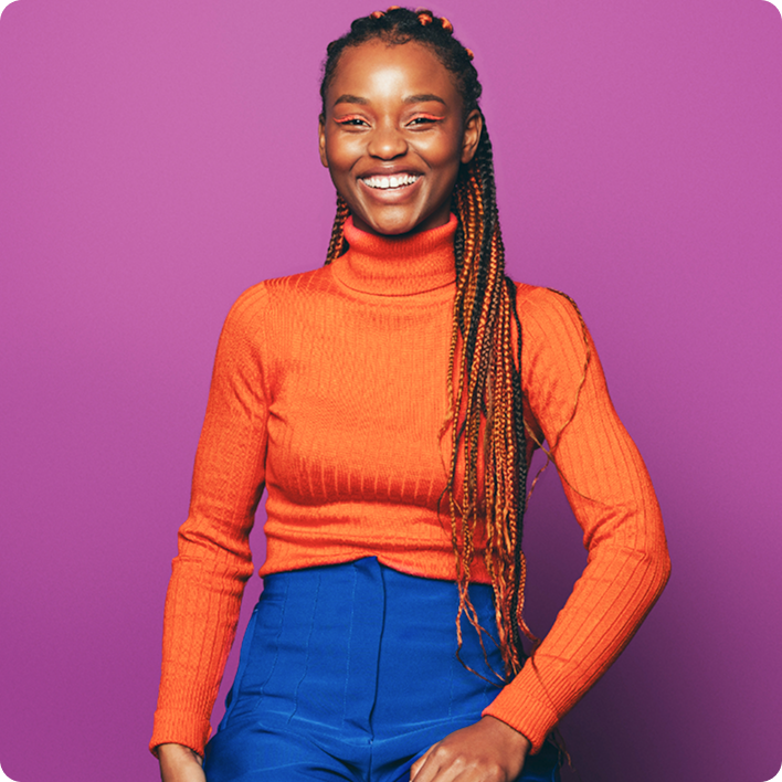 Woman with orange turtleneck smiling